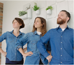  three students in front of white wall