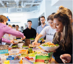  three students in front of white wall