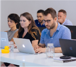  three students in front of white wall
